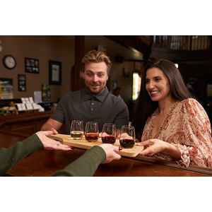 Couple with wine flight at Sprucewood Shores winery