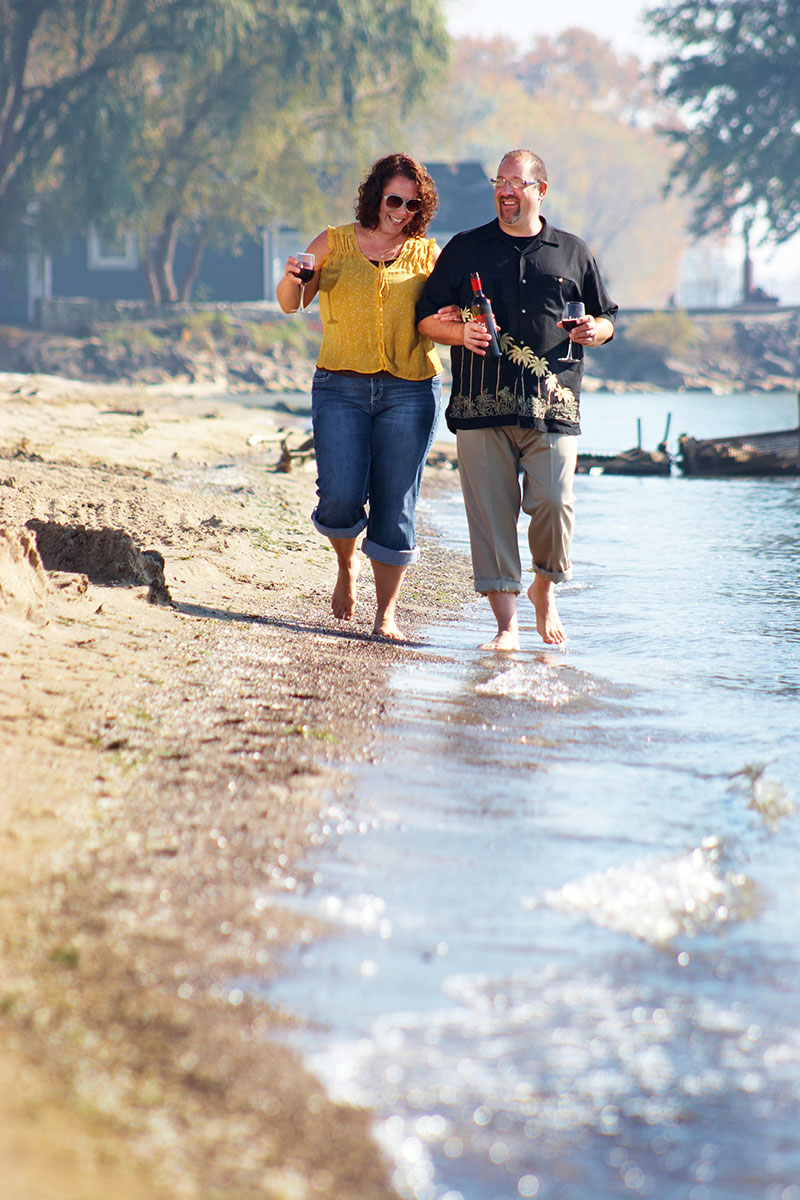 Couple without socks walking near water at Sprucewood