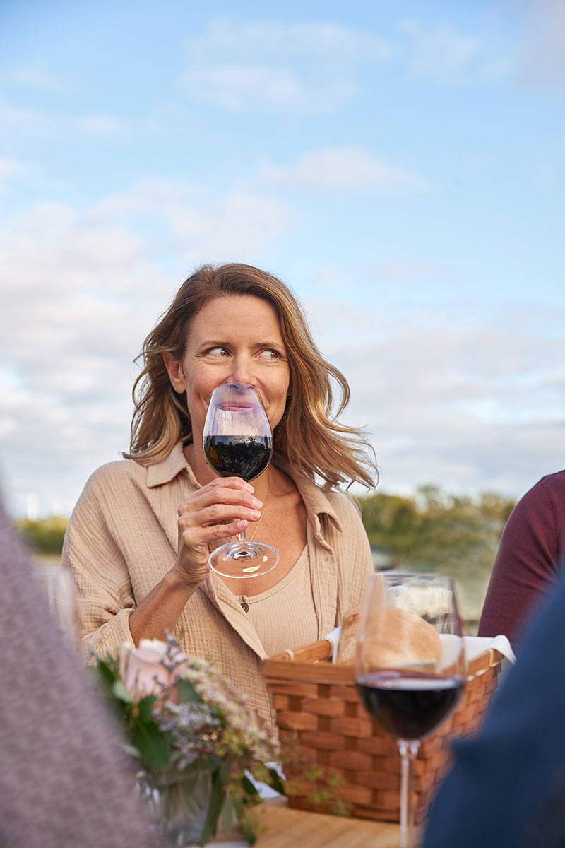 Women smiling while sipping wine
