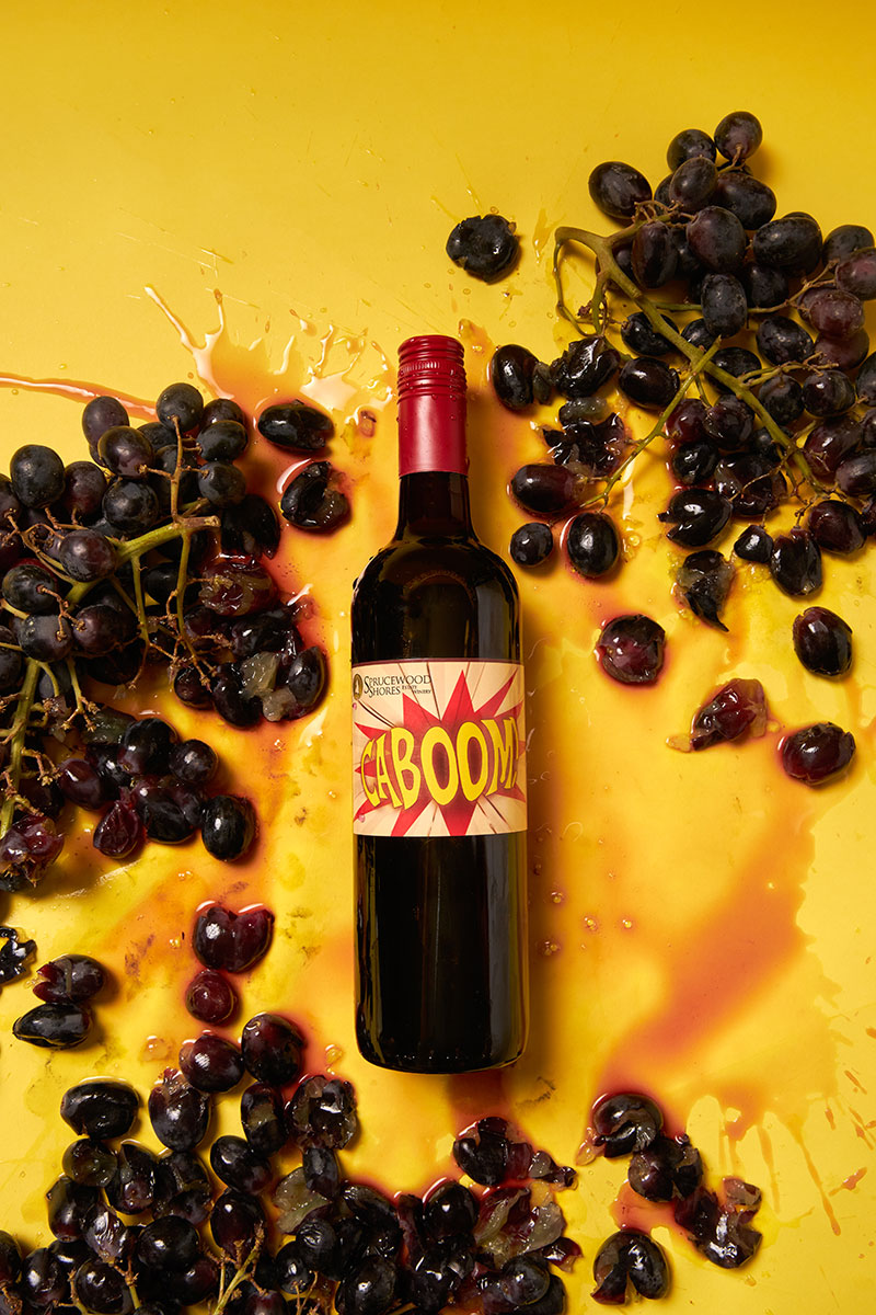 Caboom wine on yellow background