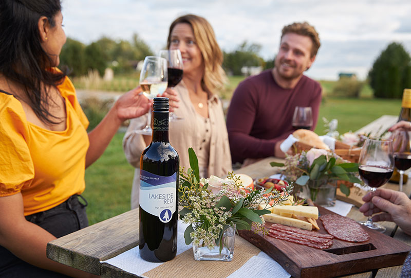 Friends enjoying Sprucewood wine outdoors